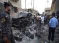 Security forces inspect the scene of a car bomb attack in Basra, Iraq, on July 14, 2013.