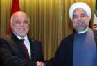 Iran’s President Hassan Rouhani (R) shakes hands with Iraqi Prime Minister Haider al-Abadi in New York on September 23, 2014
