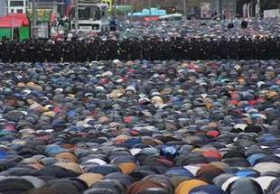 Russian security forces stand guard as Muslims attend an Eid al-Adha prayer in Moscow, Russia, on Saturday
