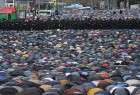 Russian security forces stand guard as Muslims attend an Eid al-Adha prayer in Moscow, Russia, on Saturday