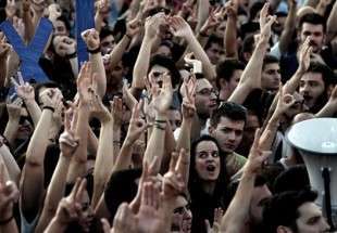 Greek demonstrators cheer during a rally calling for a 