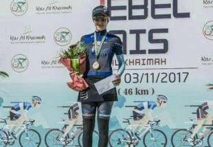 Female cyclist atop Jebel Jais Challenge