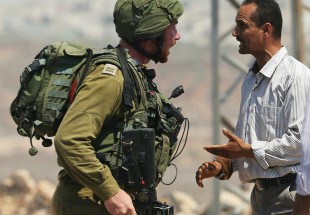 Israeli soldiers injure two Palestinians as settlers burn fields near Nablus