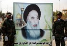 Hashed al-Shaabi forces carrying a large banner with the image of Shia cleric Grand Ayatollah Ali al-Sistani in Najaf (AFP)