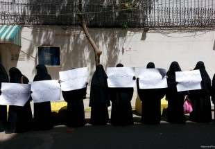Yemeni mothers can be seen holding posters during a protest against the torture their relatives are facing
