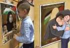 الطفل أحمد دوابشة، يعانق صورة والدته  الشهيدة.