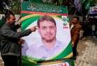 Men install a poster of 35-year-old Palestinian professor Fadi Al Batsh, who was shot and  killed by members of Israeli spy agency Mossad on April 21 in Kuala Lumpur, Malaysia.