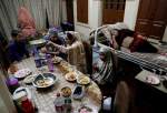 Gohar Sultan, 70, looks on as her family eats an Iftar meal at their house, in the old quarters of Delhi, India, April 25, 2020.