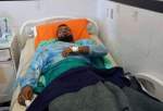 A Palestinian man in hospital after he was attacked by settlers in al-Mughayyer town.
