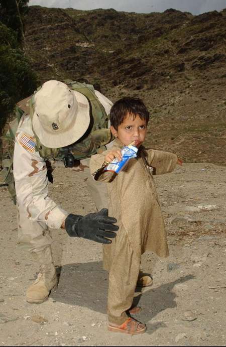 منظر استفزازي، جندي أميركي يفتش طفل أفغاني
