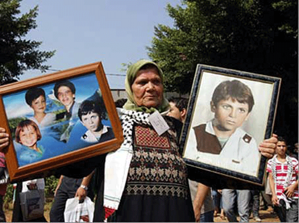 A Mother holds her sons picture who died in the massacre