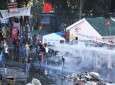 Turkish riot police use a water cannon and tear gas to disperse protesters at Istanbul’s Gezi Park on June 15, 2013.