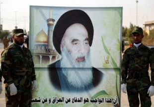 Hashed al-Shaabi forces carrying a large banner with the image of Shia cleric Grand Ayatollah Ali al-Sistani in Najaf (AFP)