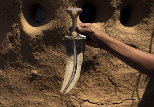A craftsman holds a dagger or ‘Jambiyya’ in Yemeni Arabic, made out of remains of missiles, in Hajjah, Yemen.