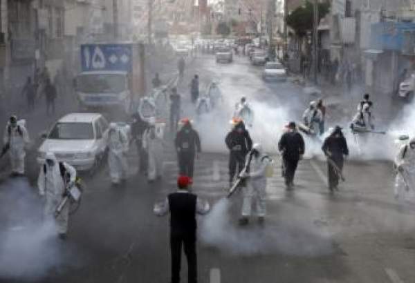 Iranian Firefighters disinfect streets in a bid to halt the spread of coronavirus, in Tehran, March 13 2020