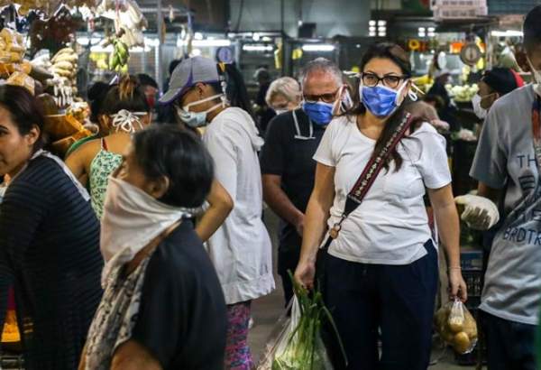 Venezuelans wearing protective face mask as they go shopping in a market.
