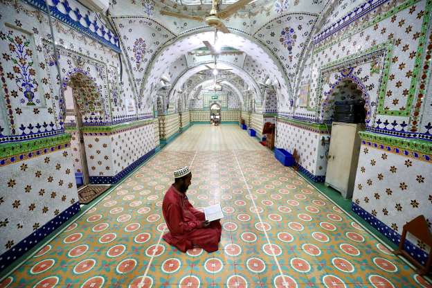 A devotee recites the Quran at a mosque during Ramadan in Dhaka, Bangladesh, on April 26, 2020.