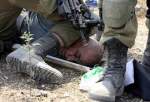 Israeli soldier kneeling on Palestinian man