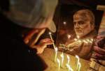 Iraqi young man lights a candle in a vigil held on the first martyrdom anniversary of top Iranian IRGC commander of Quds Force, General Qassem Soleimani and Abu Mahdi Muhandes together with their companions near Baghdad Airport.