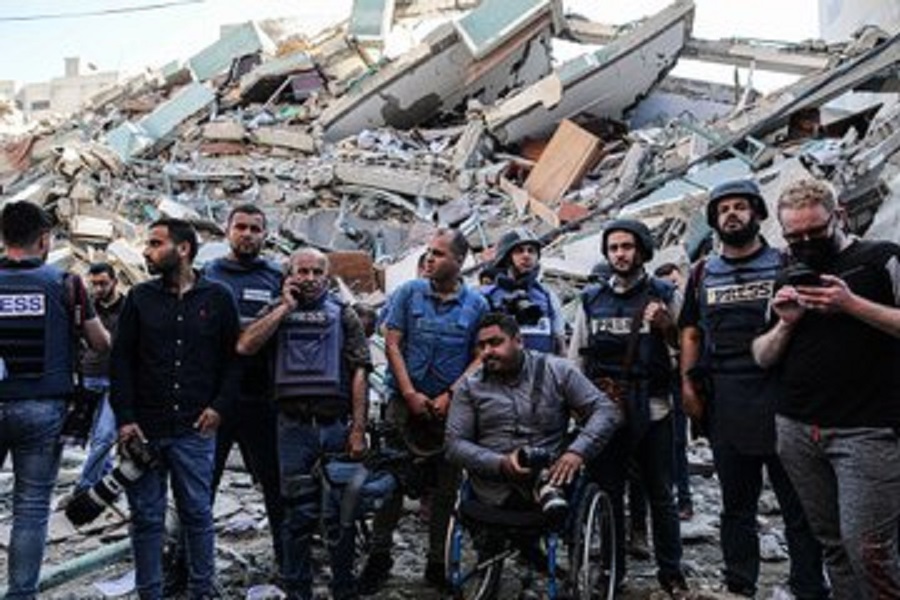 صحفيون يقفون على ركام مكاتبهم التي دمرها الاحتلال بعد قصف برج الجلاء بغزة  
