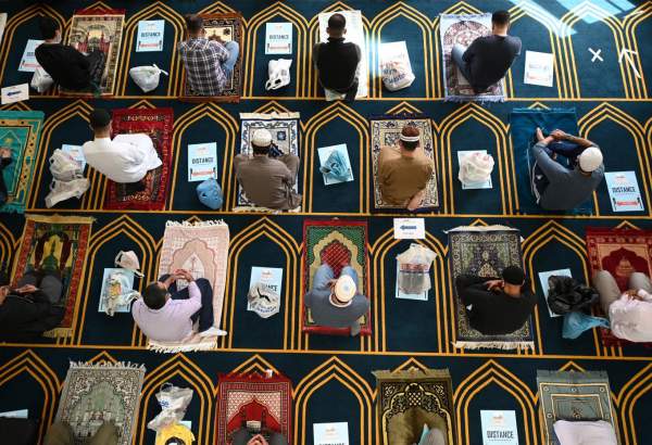 Socially distanced worshippers kneel on their prayer mats during Friday prayers at Sheffield