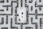FILE PHOTO: People walk with their dogs through a snow-covered garden maze in Gelsenkirchen, Germany, Wednesday, Feb. 10, 2021 ©  AP / Martin Meissner
